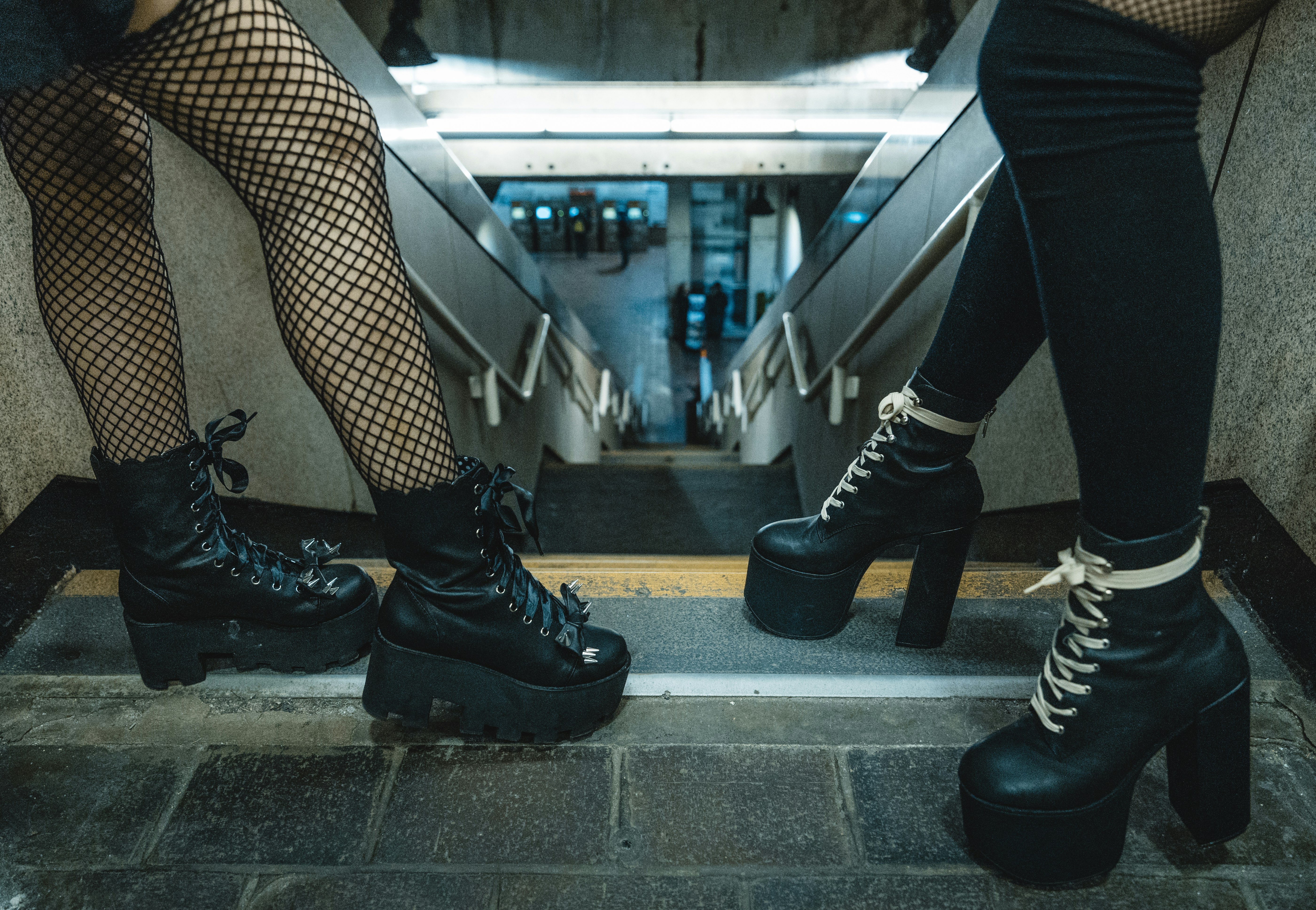 two person standing beside staircase